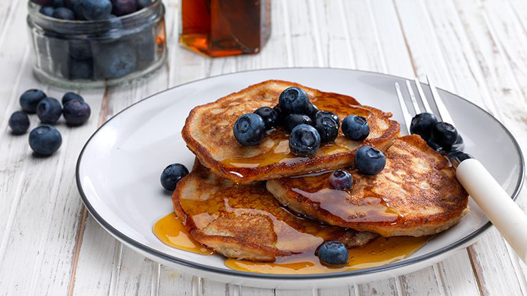 Banana Pancakes with blueberries and maple syrup