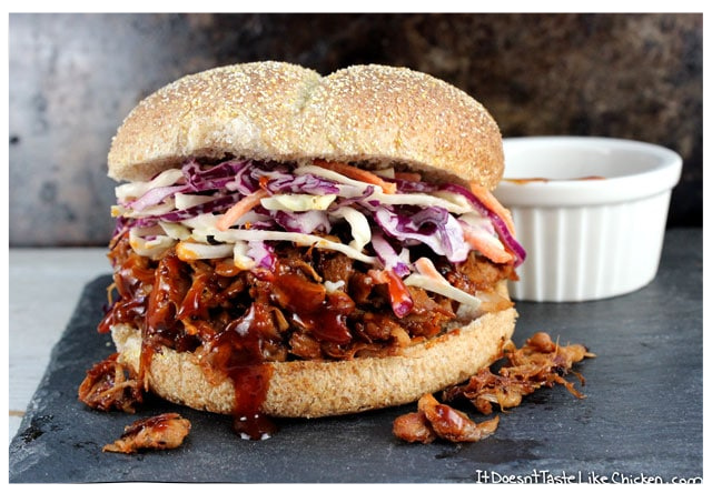 Vegan bbq pulled pork topped with cabbage slaw on a sesame seed ladden bun