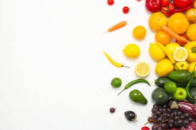 Rainbow composition with fresh vegetables and fruits on white background, flat lay