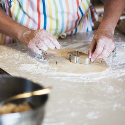 Unidentified person baking with dough 