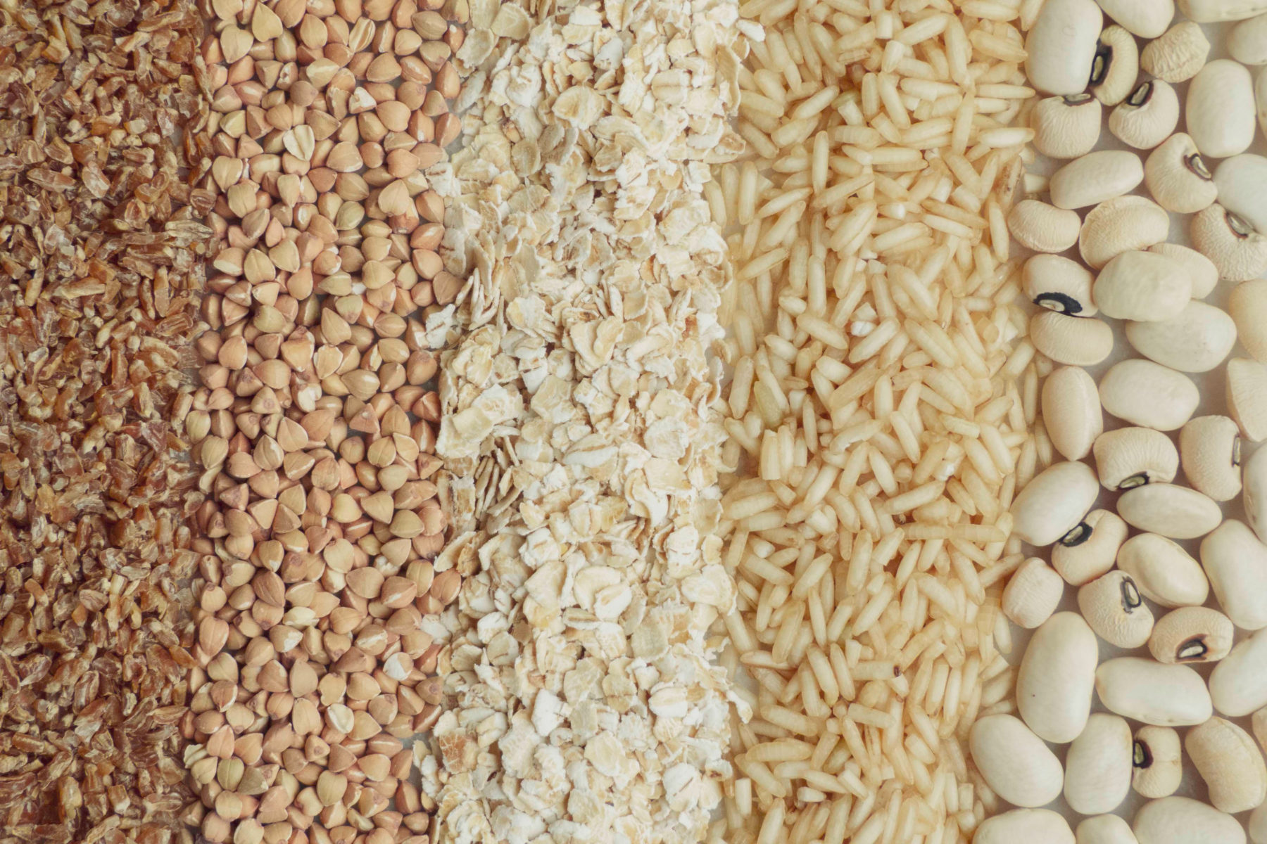A flatlay of grains, nuts and pulses