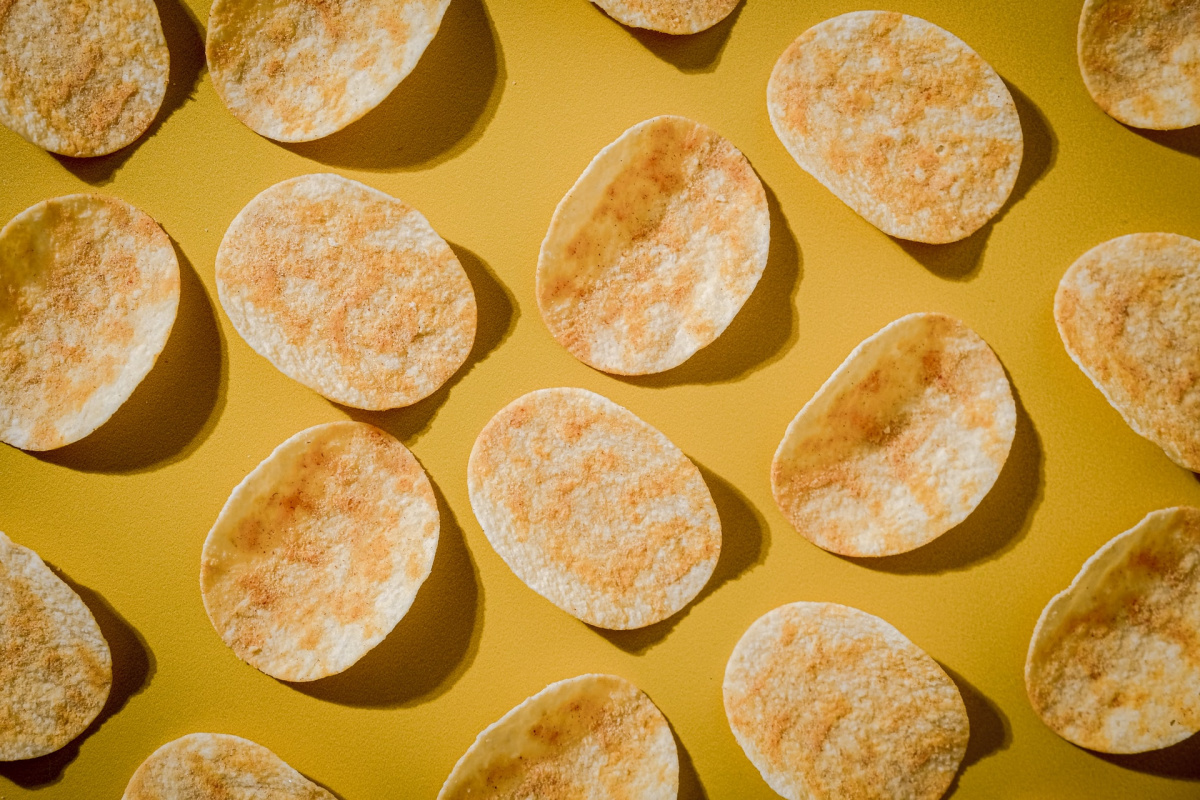 A flatlay of Pringles crisps on a yellow surface