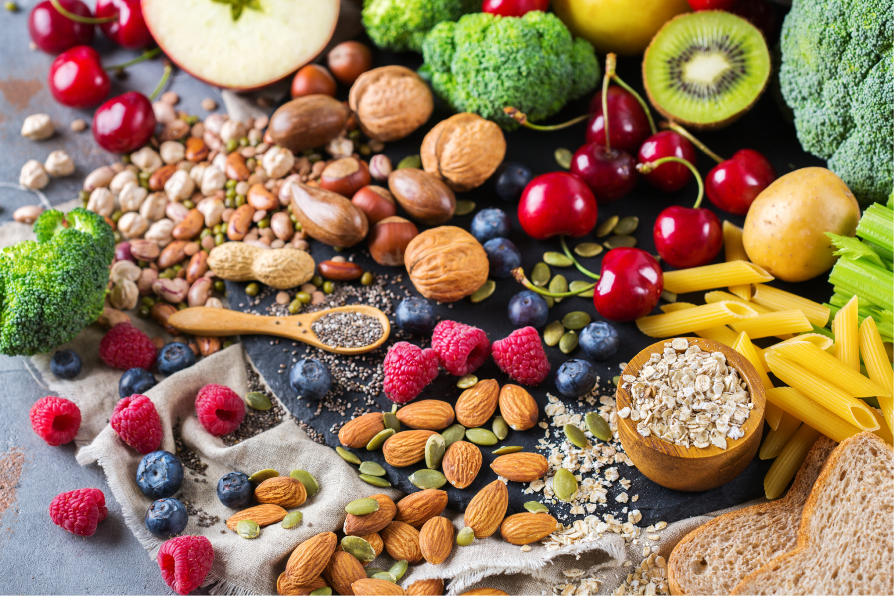 An array of healthy fruits, vegetables, nuts and pulses 