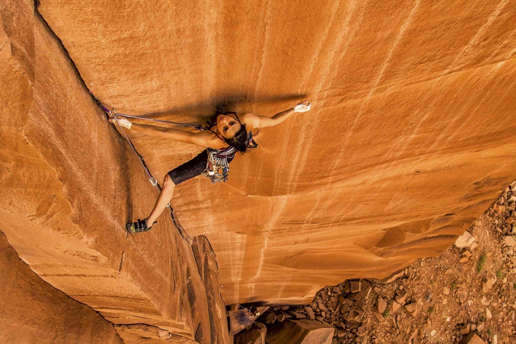 An image of Steph Davis climbing up a sheer rock face