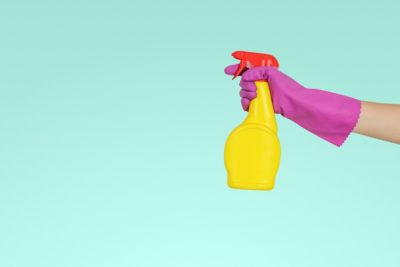 Unidentified hand spraying a cleaning product. Our guide to vegan and cruelty-free cleaning products will help with your spring clean.