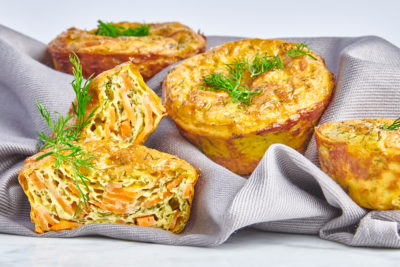 Smoked salmon muffins arranged on a cloth napkin and garnished with fresh herbs
