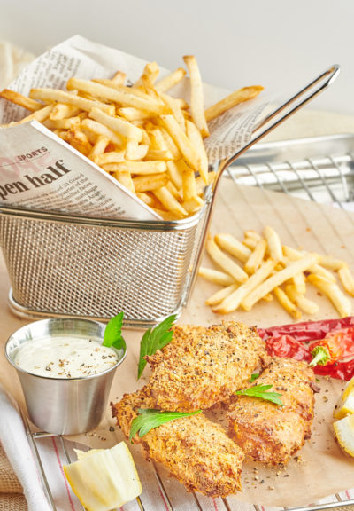 Vegan fried fish with a basket of French fries service with tartar sauce