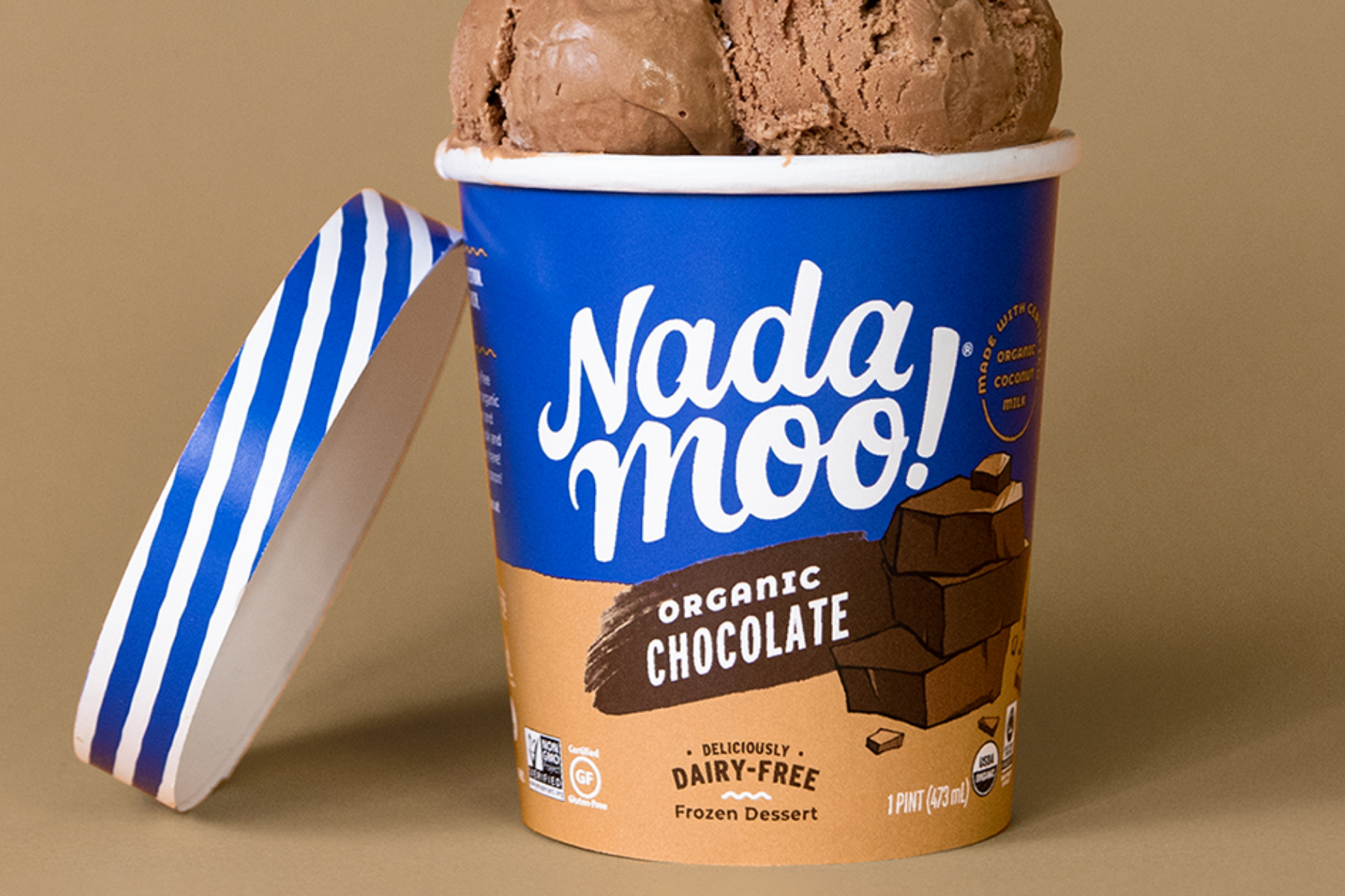 Scoops of vegan chocolate ice cream atop a pint of NadaMoo! Organic Chocolate ice cream