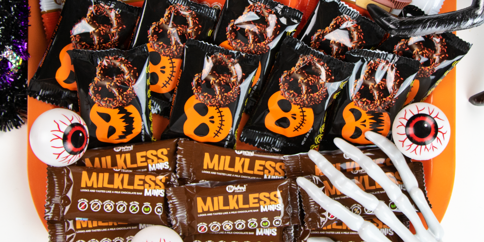 A skeleton hand is reaching for vegan Halloween candy
