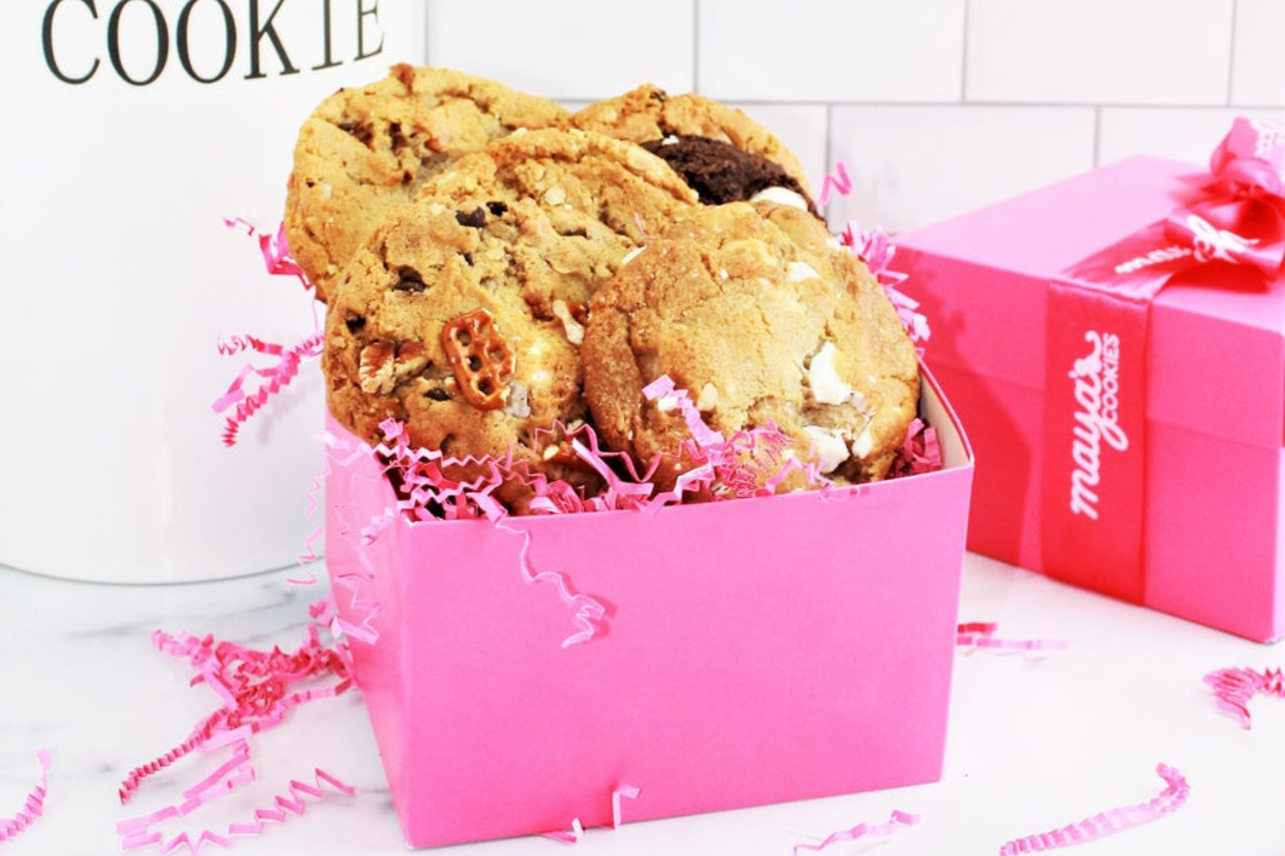Maya's cookies assorted flavors in a pink box with a bow