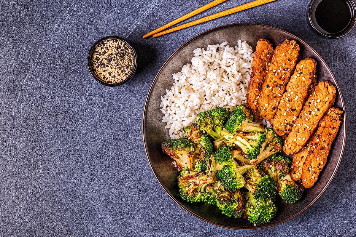 Fried tempeh with rice and broccoli, traditional Indonesian cuisine.