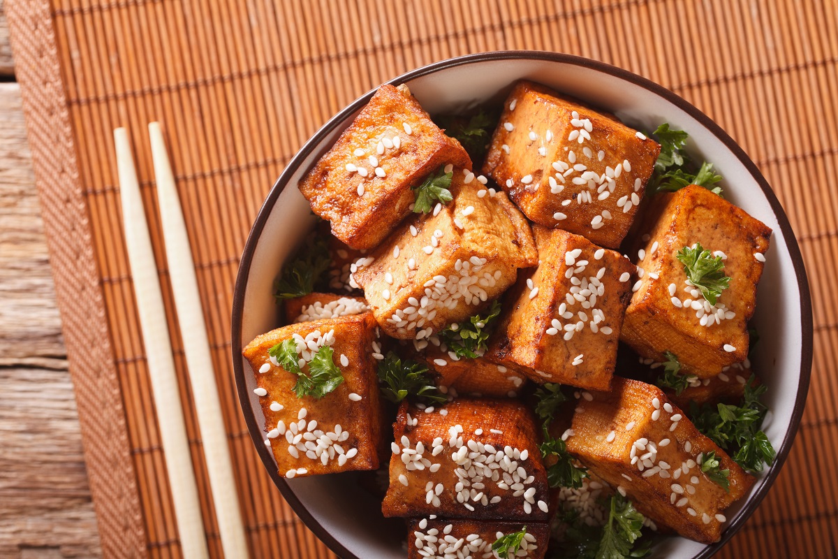 Stir fry tofu with sesame seeds and herbs close-up. horizontal t