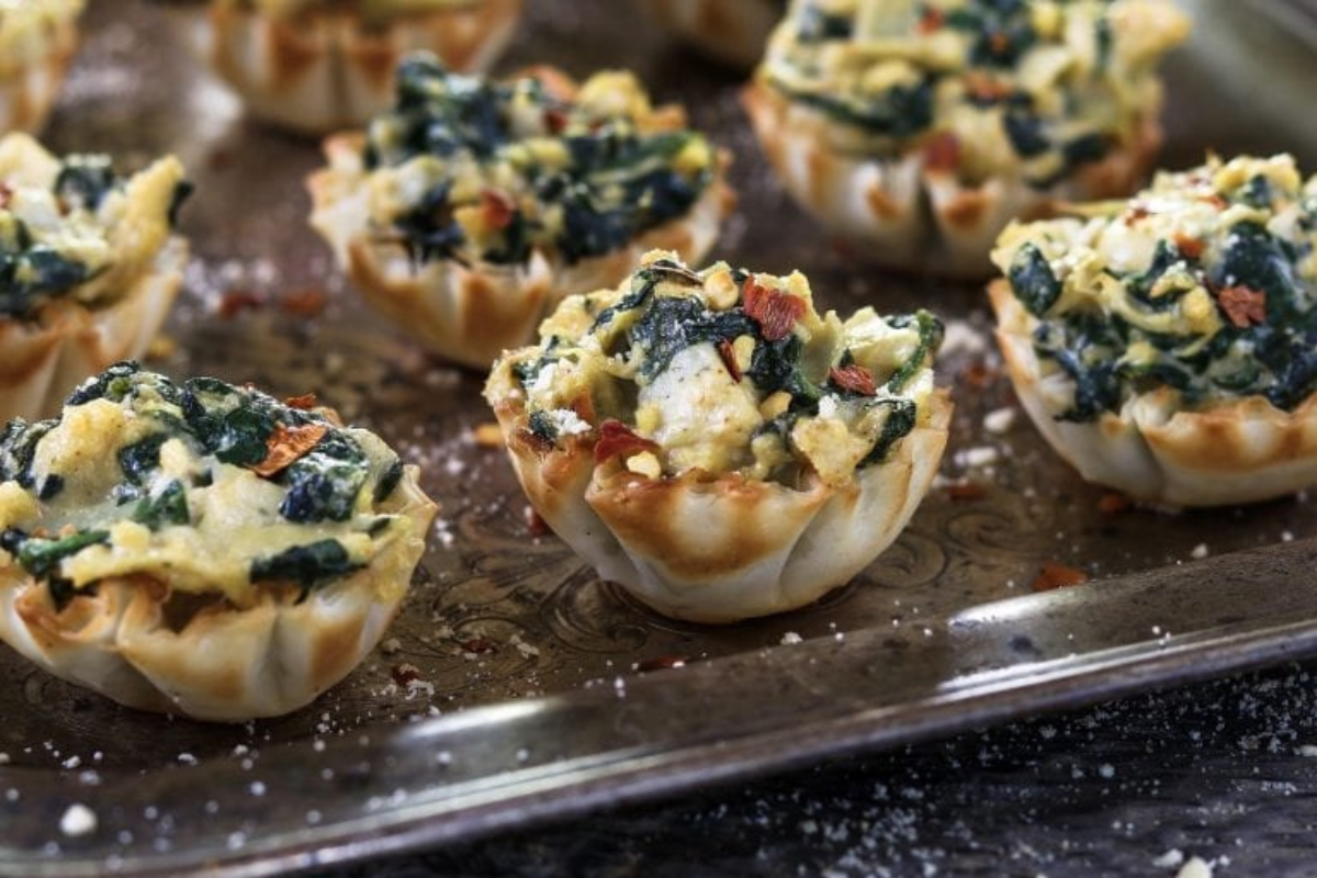 Phyllo pastry shells stuffed with melty spinach and artichoke mixture