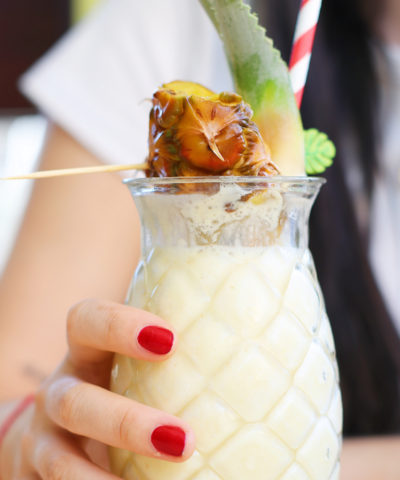 a detoxing pina colada in a pineapple shaped glass