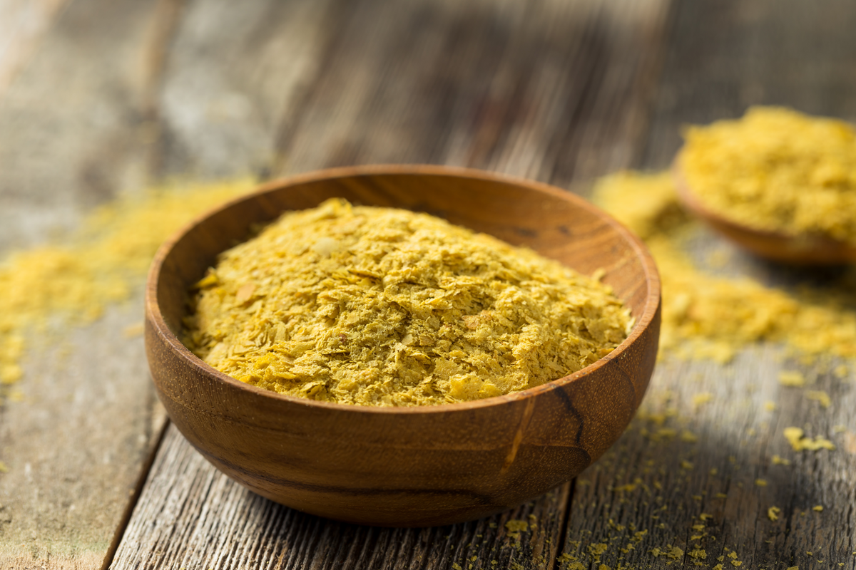 Nutritional yeast flakes in a wooden dish