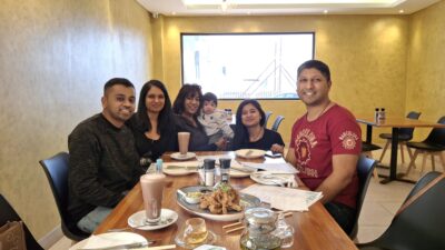 Udesh and his family enjoying a meal together